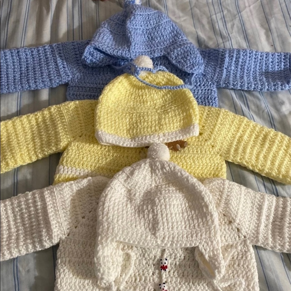 Knitted baby sweaters,shoes, and a diaper bag